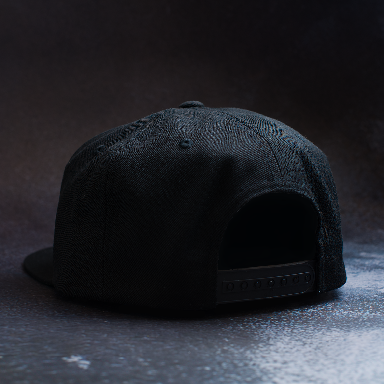 Black snapback hat with embroidered Fa Ram logo patch on the front. Rear view.