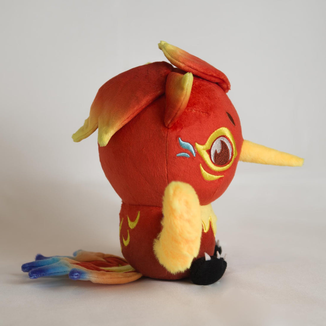 Auri Collectible Plush, right profile showing rainbow tail