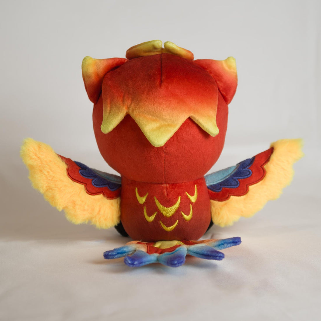 Auri Collectible Plush, back view showing embroidered feathers