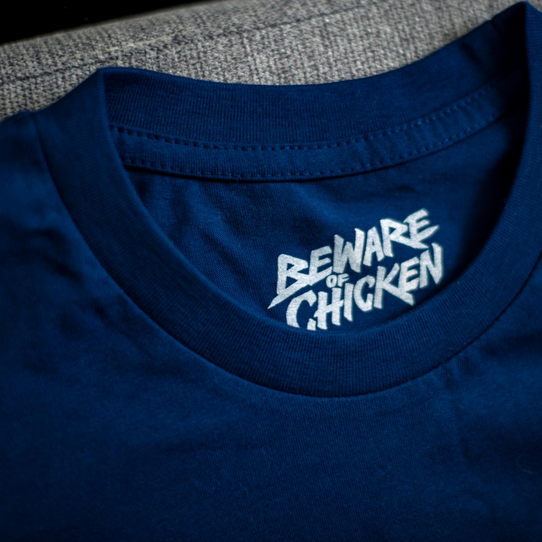 CLose up of logo neck tag on Cast Of Characters t-shirt 
