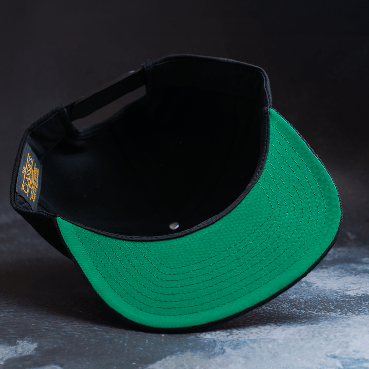 Black snapback hat with embroidered Fa Ram logo patch on the front. Bottom of hat view.